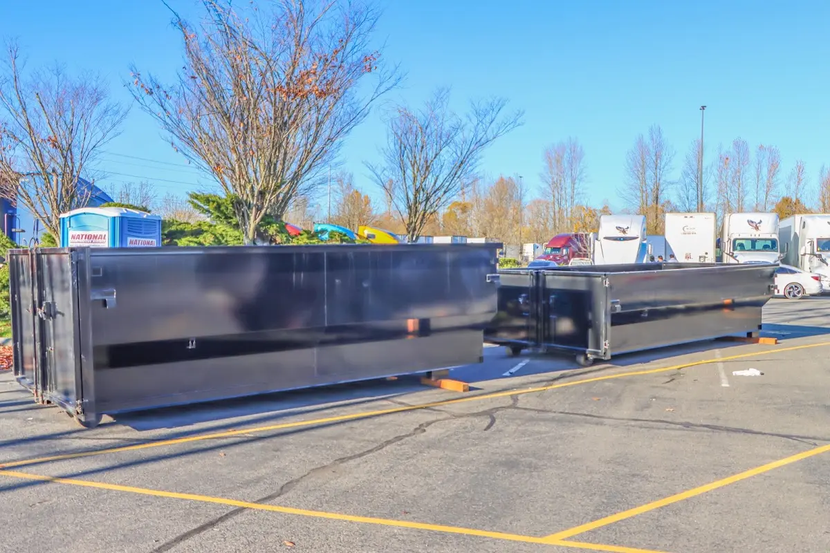 Professional dumpster rental service with roll-off container on residential driveway in Oceano